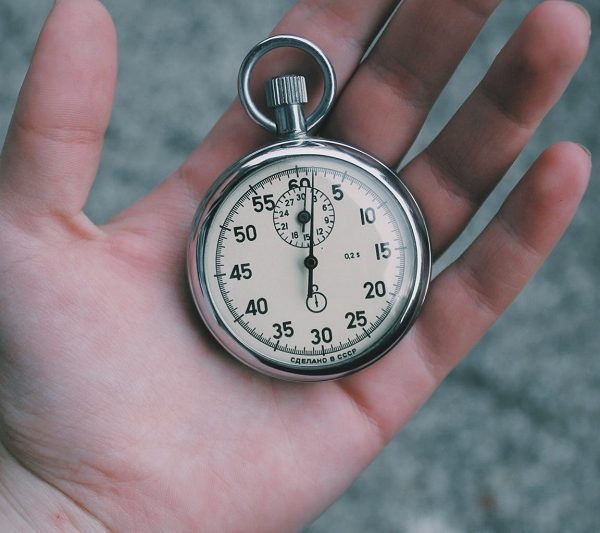 Hand with a clock in it as time management tool