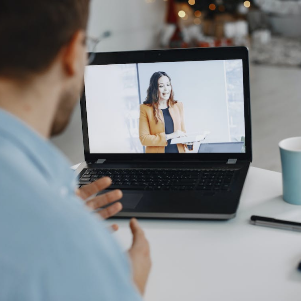 A remote employee having an online meeting and communicating with a coworker