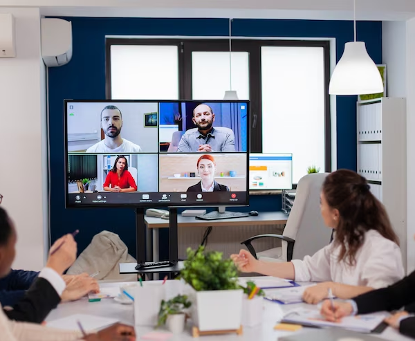Inhouse employees having an engaging meeting with their remote coworkers